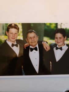 Grandfather with two grandsons in tuxedos